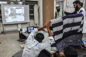 artists presenting crafts before a Zoom audience