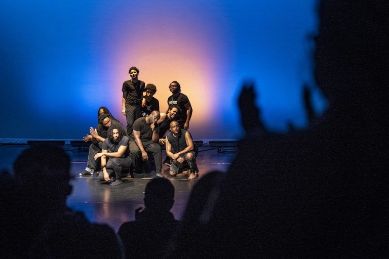 students posing on a stage
