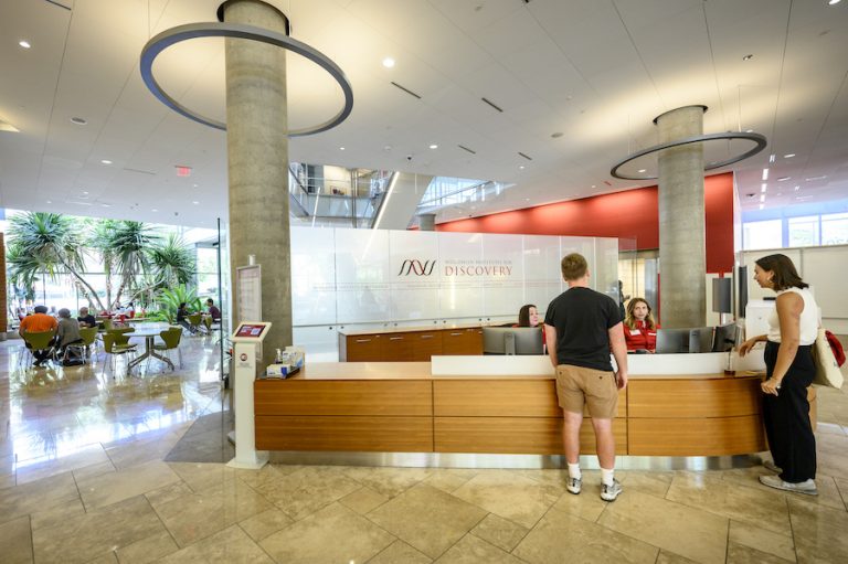 visitors at the welcome desk of the Wisconsin Institute of Discovery
