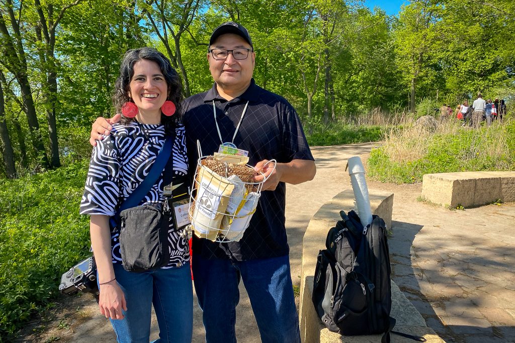 Catherine Reiland presents Ho-Chunk Nation Tribal Historic Preservation Officer Bill Quackenbush with a gratitude bundle after his presentation. (Photo by Laura Wyatt)