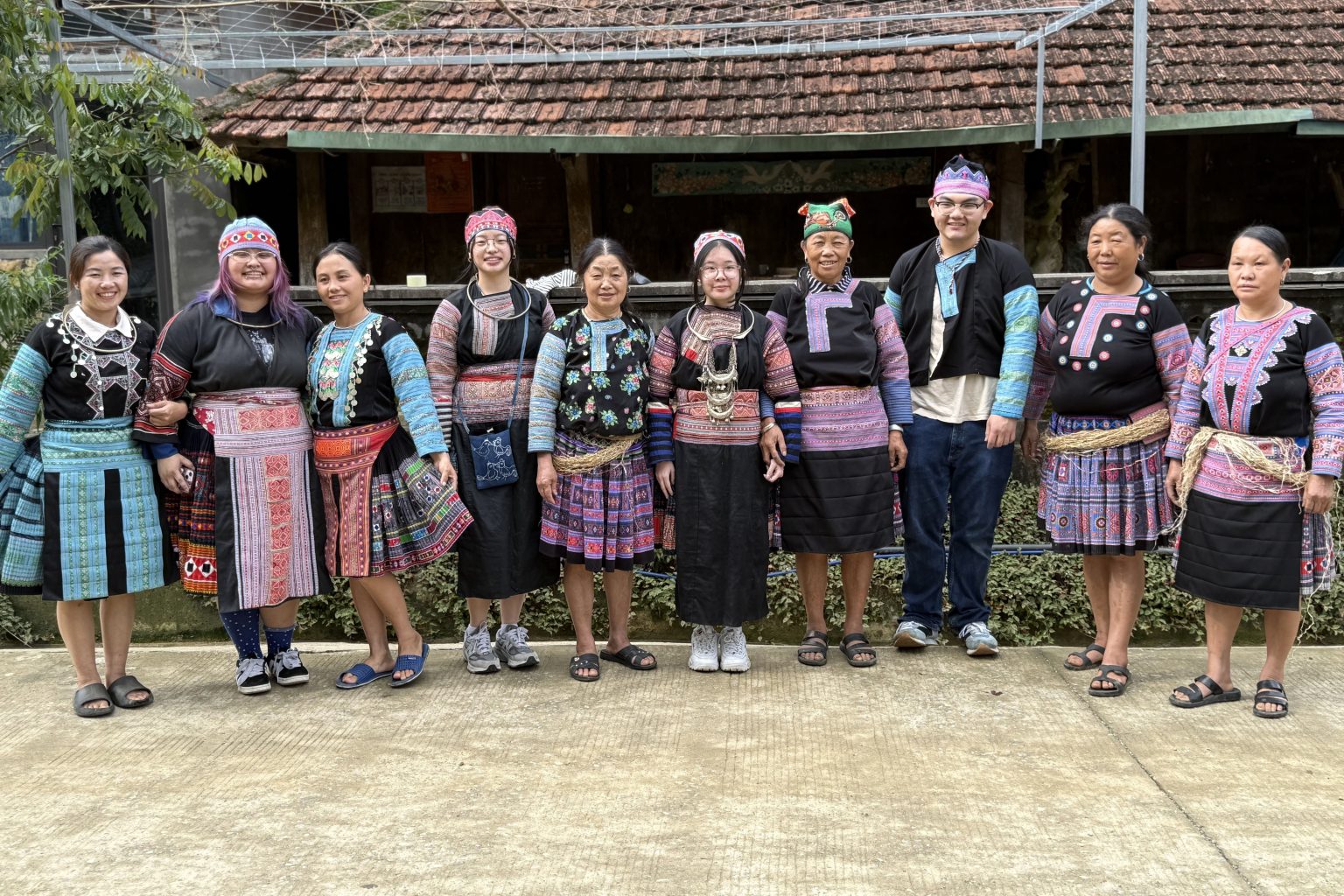 group of students modeling Hmong textiles