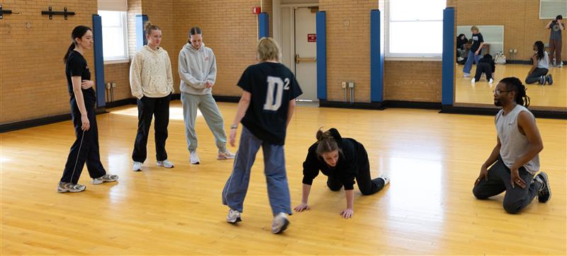dance instructor with a group of students, rehearsing a dance