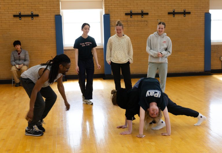 dance instructor with a group of students, rehearsing a dance