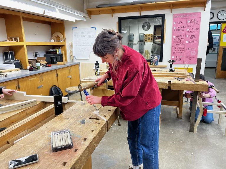 student performing woodworking