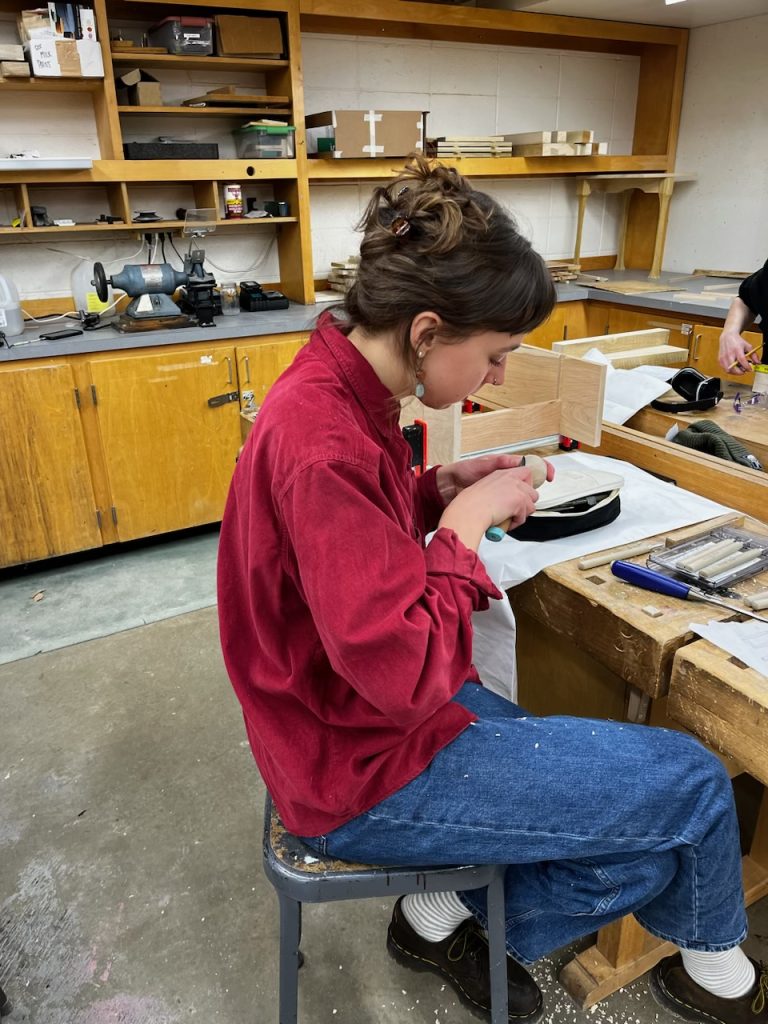 student performing woodworking