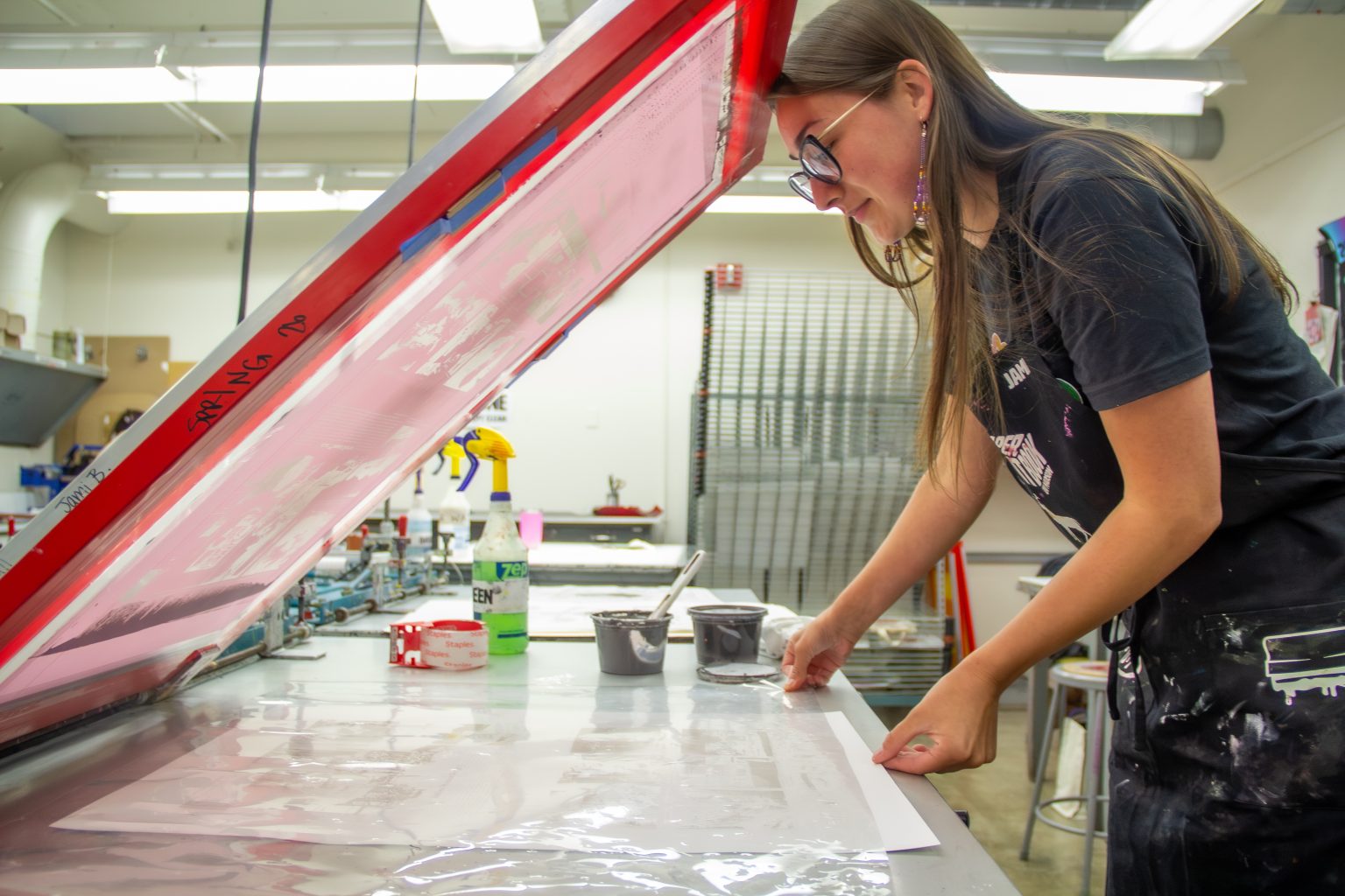 Jami Balicki pressing a mylar sheet into a piece of hand-made cornpaper. Photo by Ted Hyngstrom