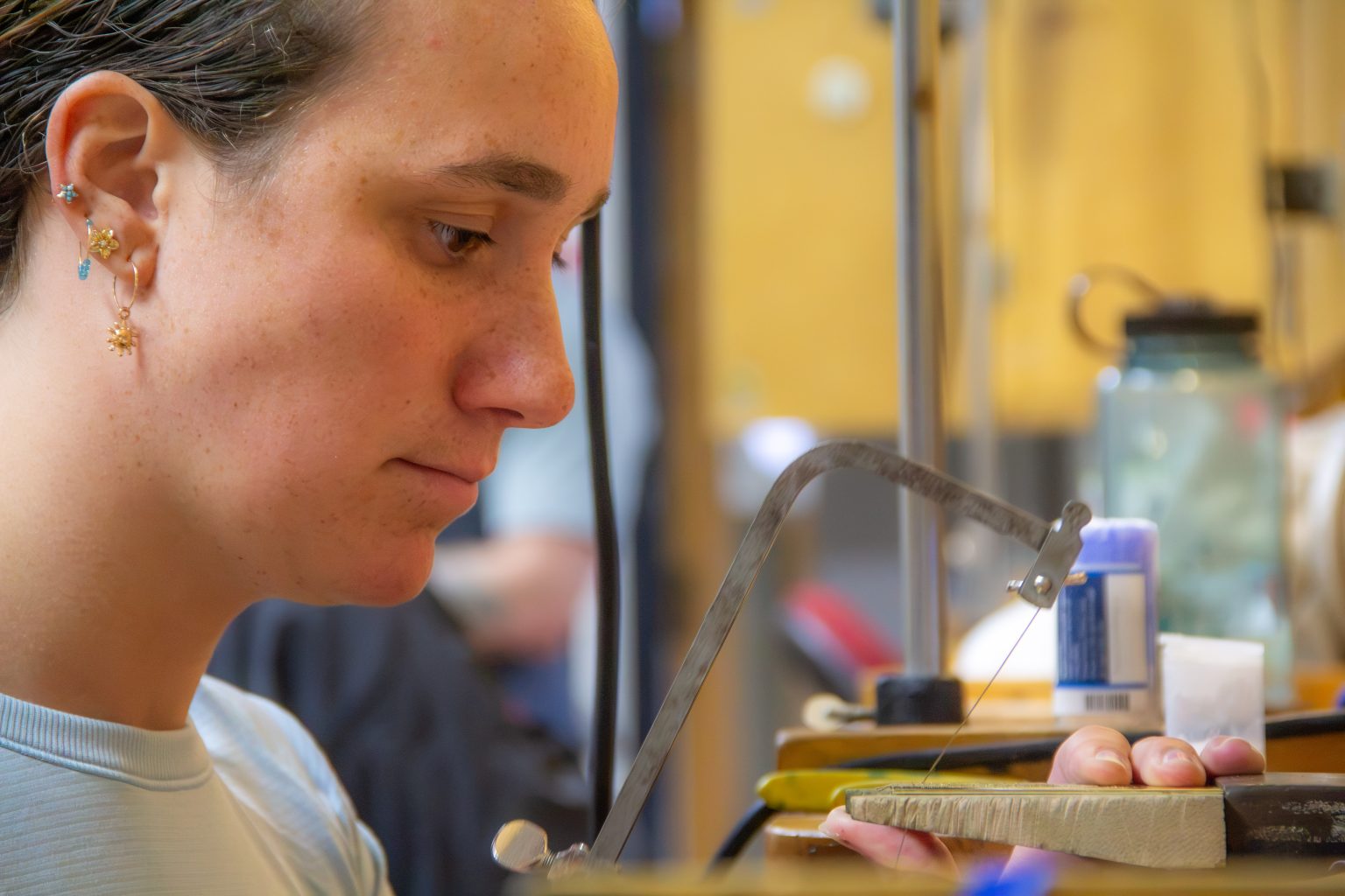 Maddie Waggoner sawing a bezel. Photo by Ted Hyngstrom