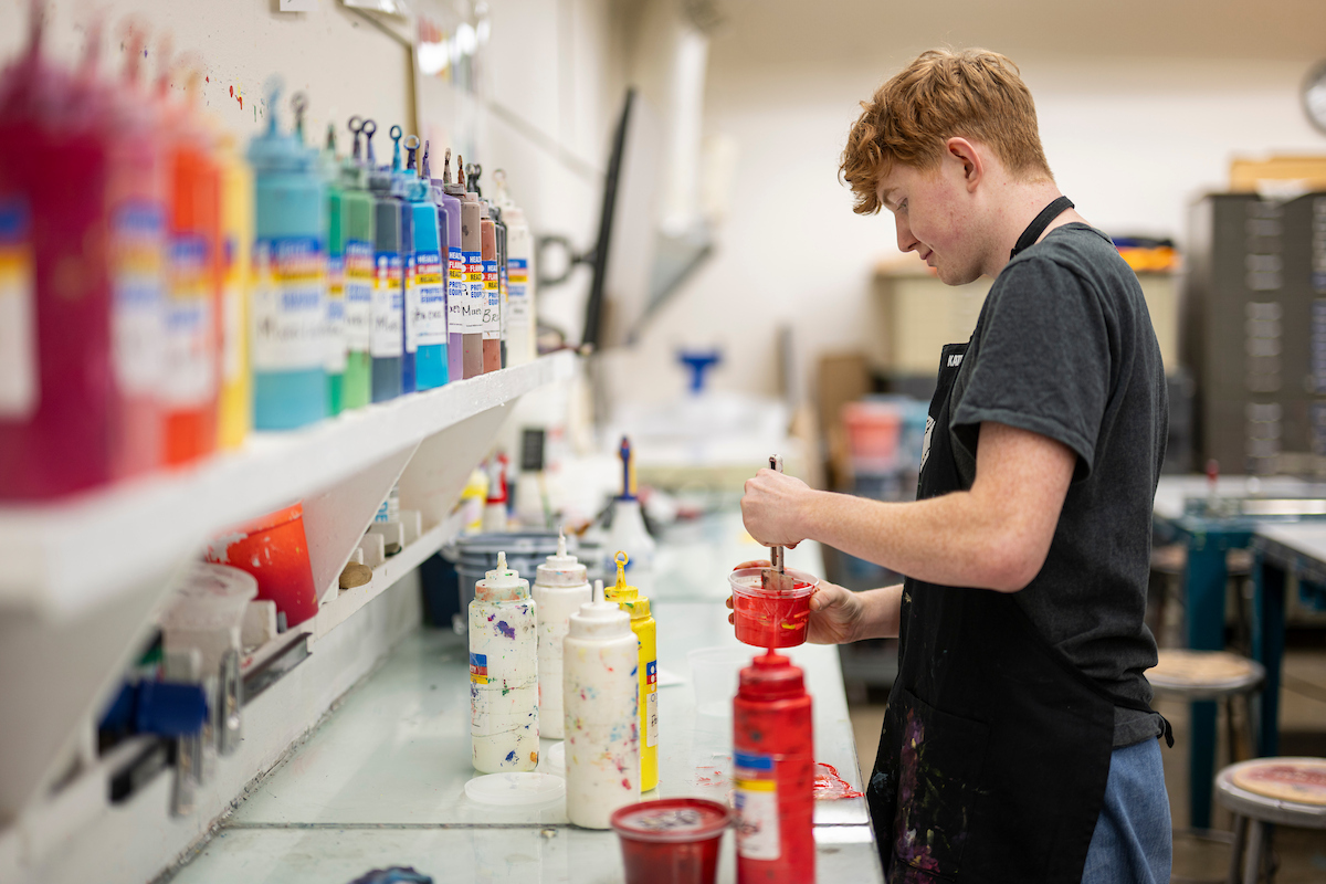 Printmaking student working in the screen printing studio inside of the Mosse Humanities Building at the University of Wisconsin-Madison. (Photo by Bryce Richter / UW–Madison)