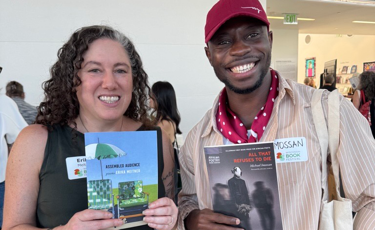 UW–Madison Creative Writing professor Erika Meitner and current MFA in Poetry student, Michael Imossan, each hold up their recently published books